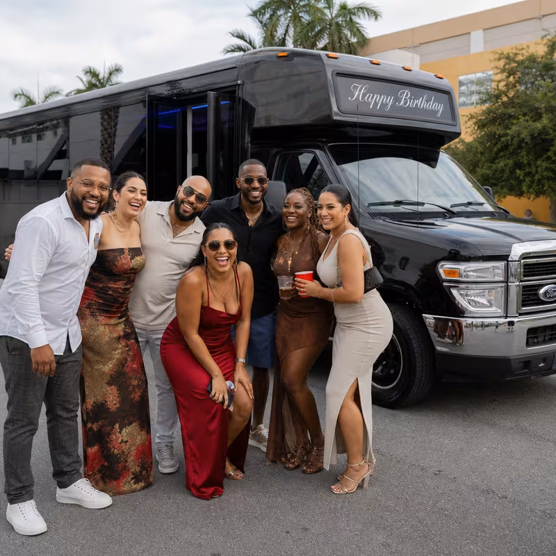 Group boarding a white charter bus for Birthday Transportation transportation in San Francisco
