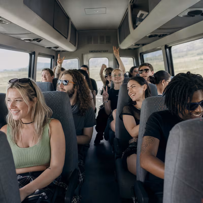 Party bus interior with wraparound leather seating and LED lighting in San Francisco