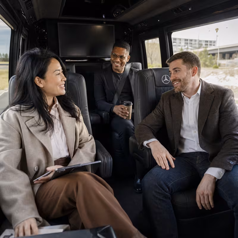 Group boarding a white charter bus for Corporate Transportation transportation in San Francisco