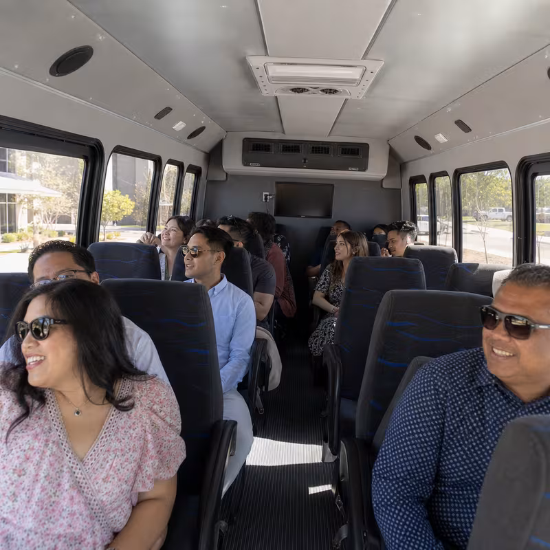 Group boarding a white charter bus for Private Event Transportation transportation in San Francisco