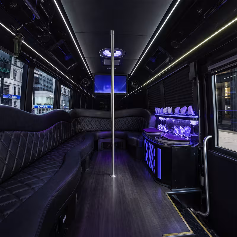 Party bus interior with wraparound leather seating and LED lighting in San Francisco