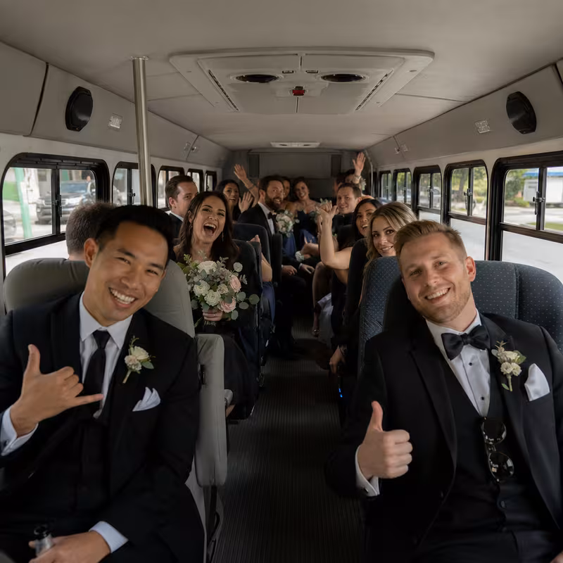 Group boarding a white charter bus for Wedding Transportation transportation in San Francisco