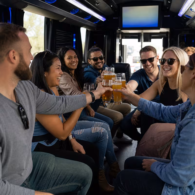 Group boarding a white charter bus for Winery & Brewery Tour Transportation transportation in San Francisco