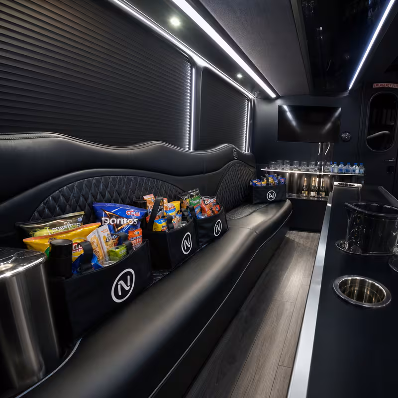 Party bus interior with wraparound leather seating and LED lighting in San Francisco